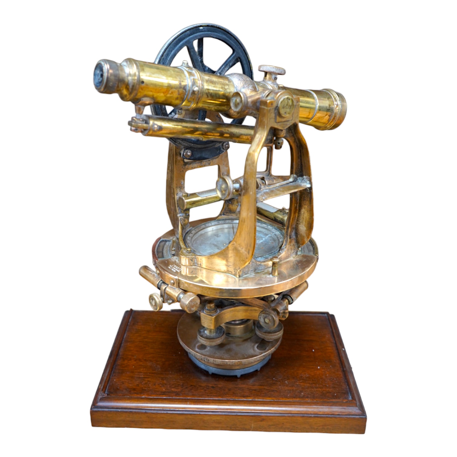 An early 20th century American brass theodolite by Keuffel and Esser Co. mounted on a mahogany base, 39.5cm high. Condition - fair to good.